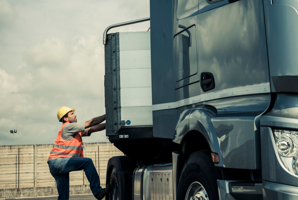 truck driver climbing their truck