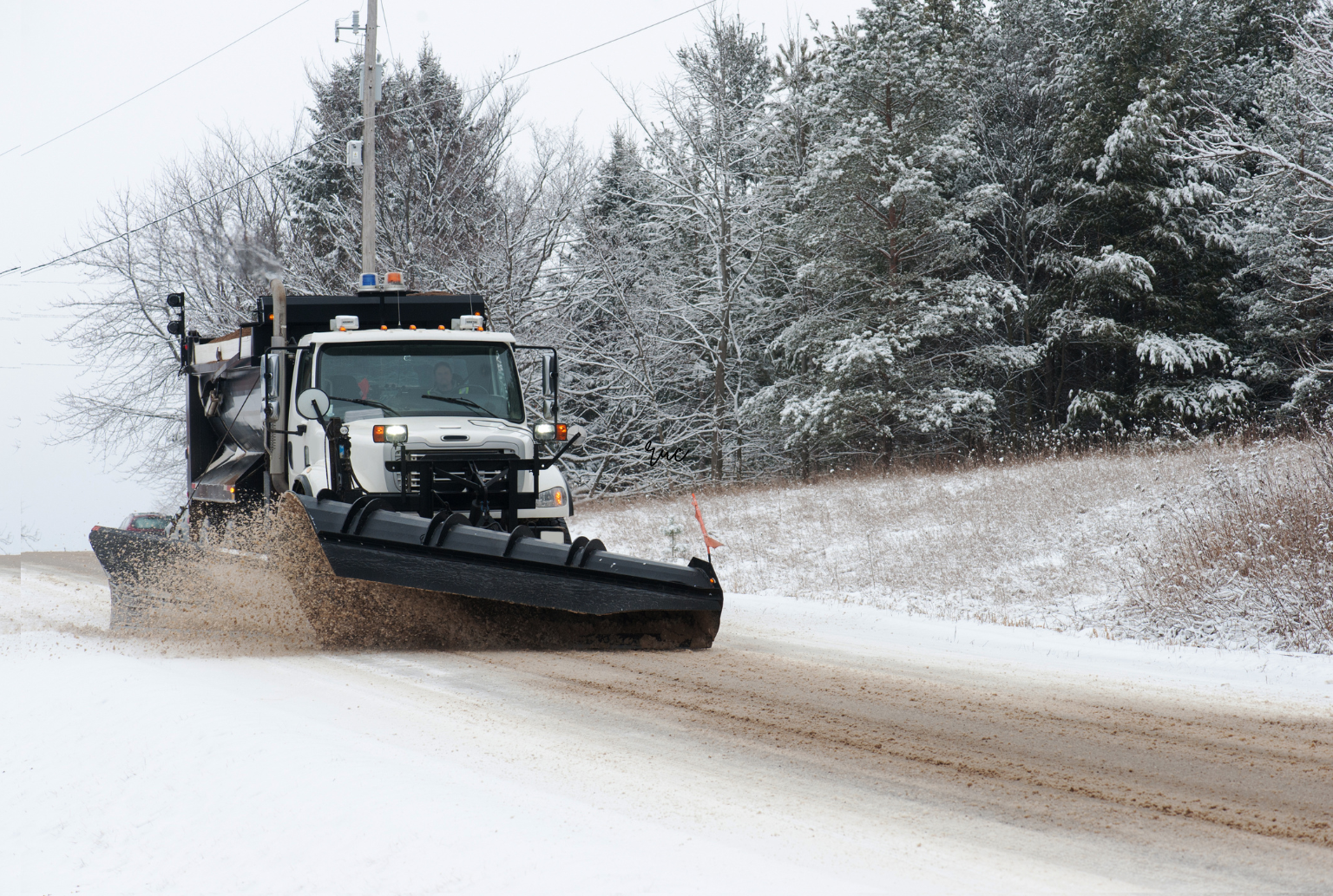 truck plowing sand and snow