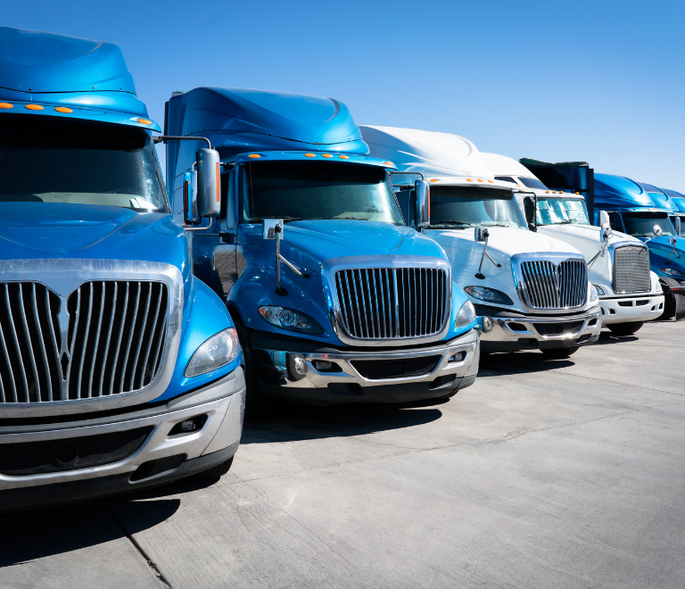 blue and white semi trucks lined up