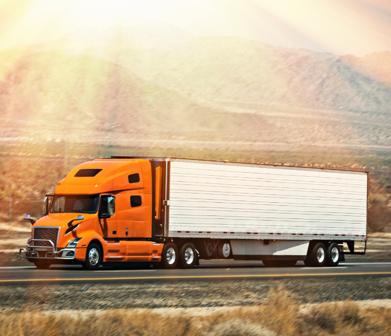 orange semi truck with sun rays