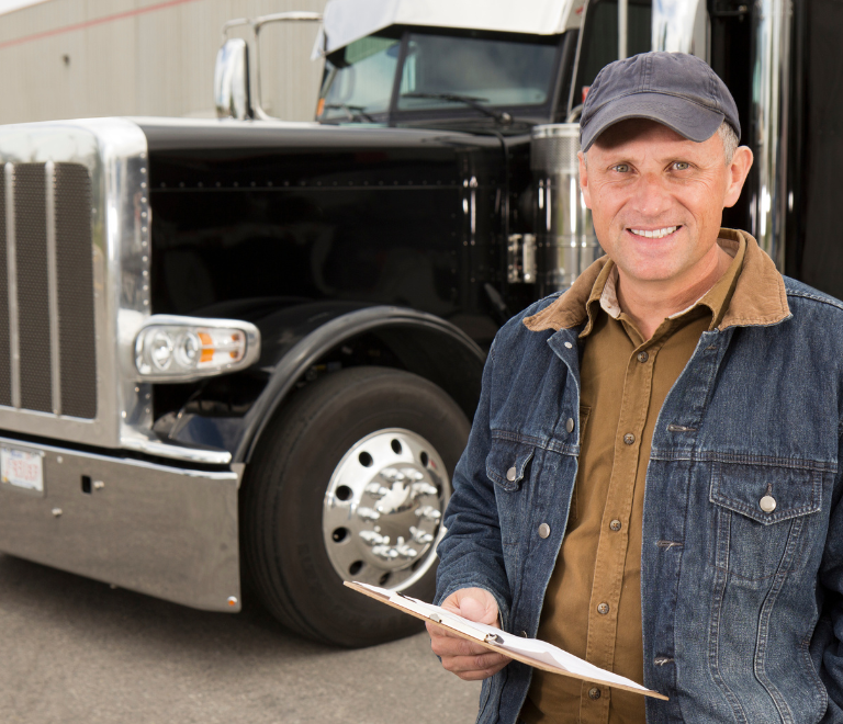truck driver smiling in front of truck
