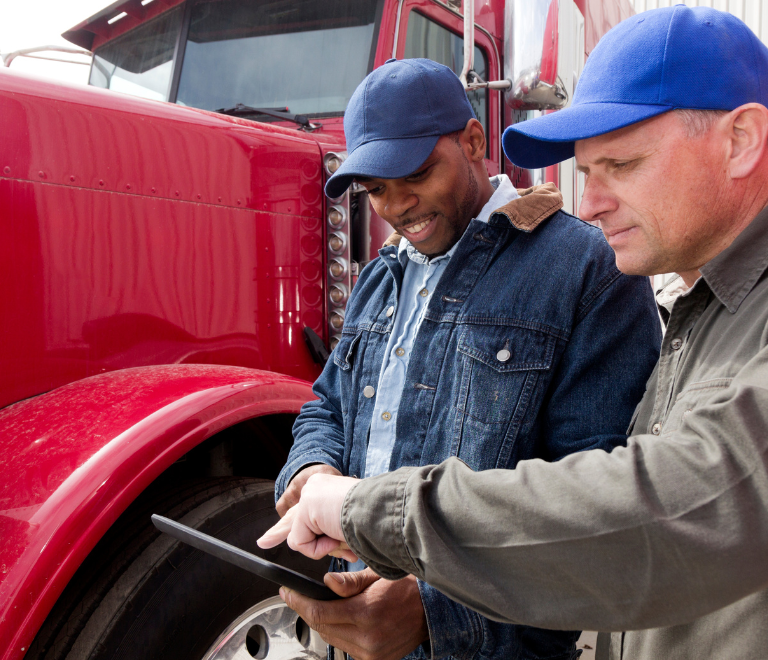 two-truck-drivers-looking-at-trucking-app
