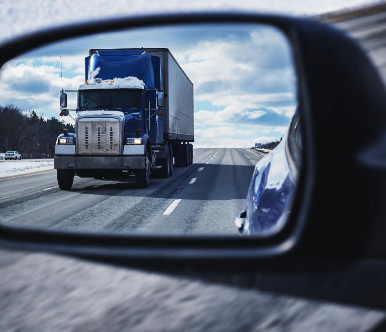 blue semi truck in mirror