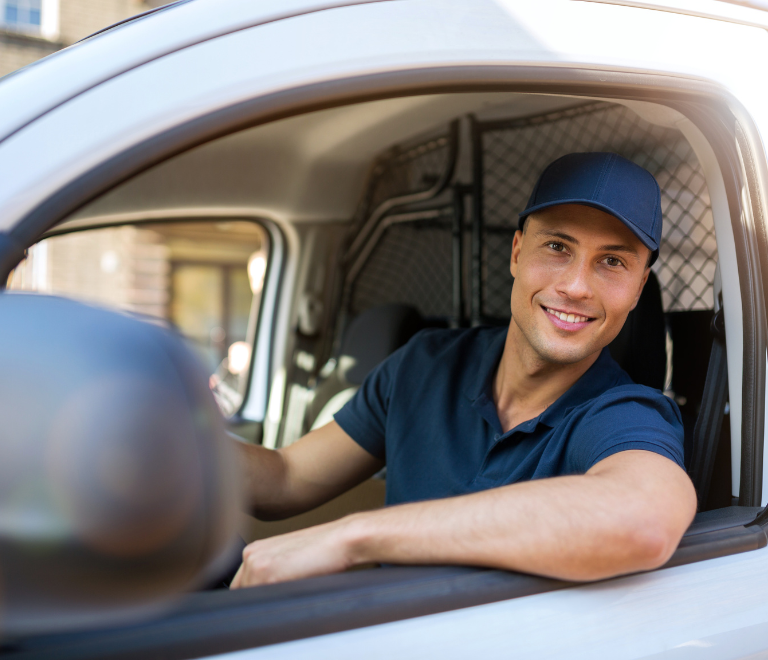 semi truck driver driving and smiling