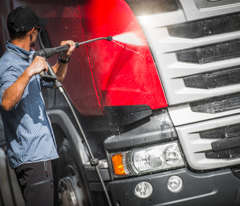 truck driver cleaning a truck